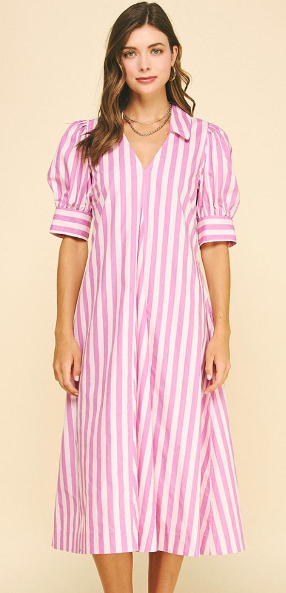 Woman wearing a pink and white striped dress on a beige background